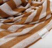 Striped fabric with brown and white pattern and a visible brand label.