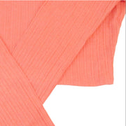 Folded coral-colored fabric on a white background