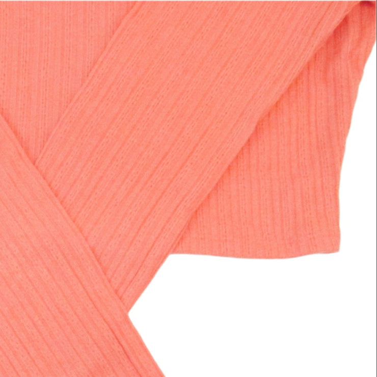 Folded coral-colored fabric on a white background