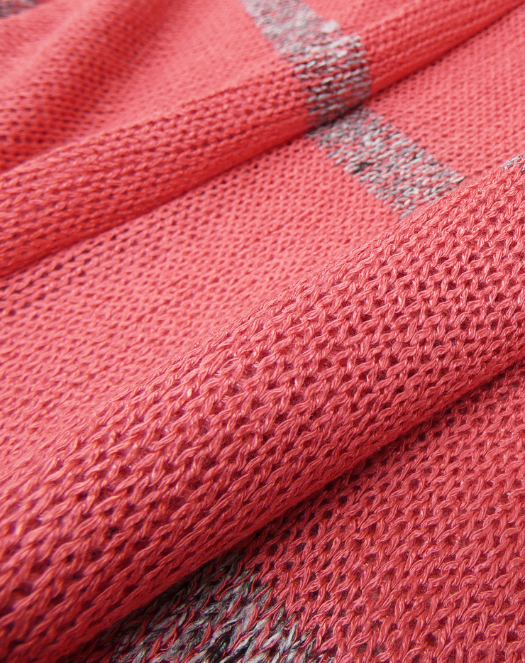Close-up of coral jumper with a striped pattern
