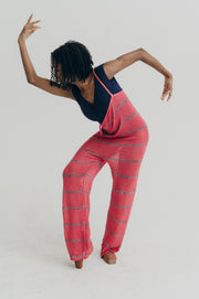 Person wearing a pink striped jumper on a white background