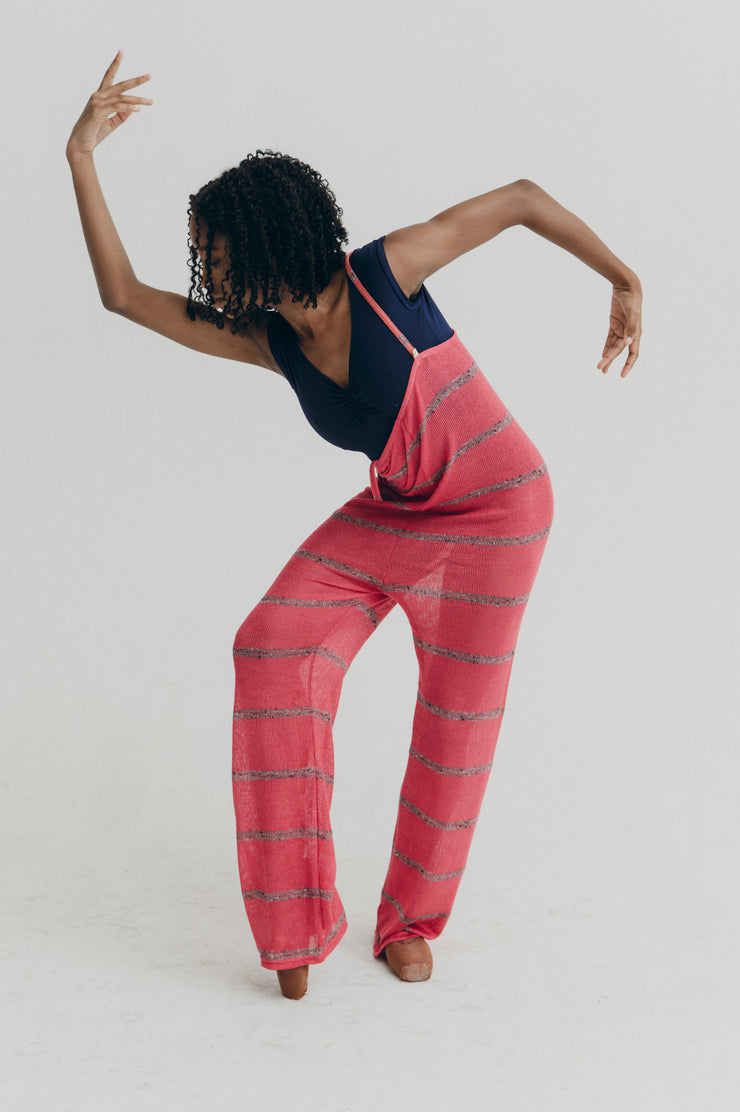 Person wearing a pink striped jumper on a white background
