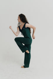 Woman wearing a green jumper against a plain background
