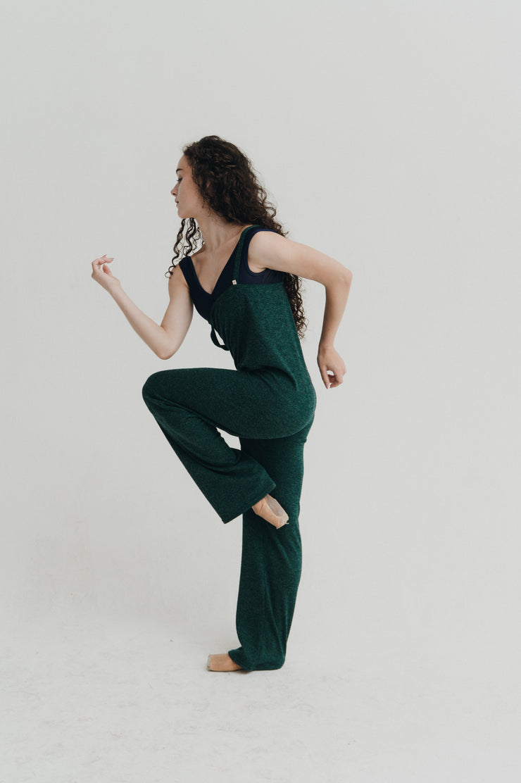 Woman wearing a green jumper against a plain background