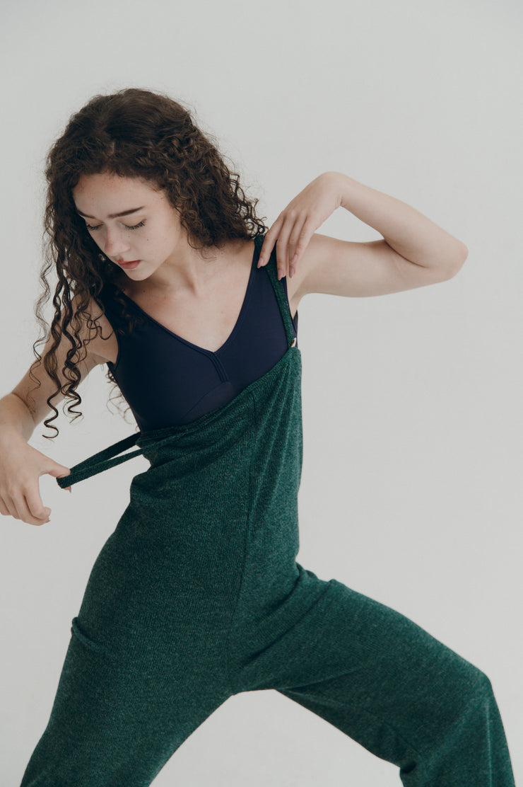 Person wearing a green jumper with a plain background