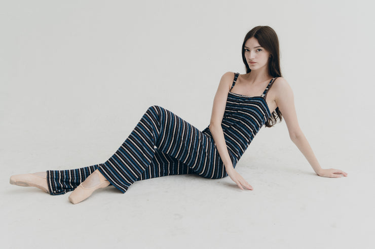 Woman wearing a striped jumpersitting on a white background