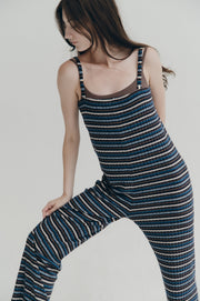 Woman wearing a blue striped jumper against a plain background