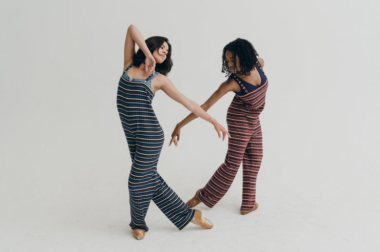 Two women in striped jumpers posing against a plain background