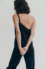 Person wearing a navy jumper against a plain background