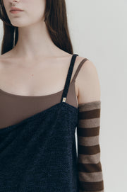 Woman wearing a dark blue jumper with against a white background